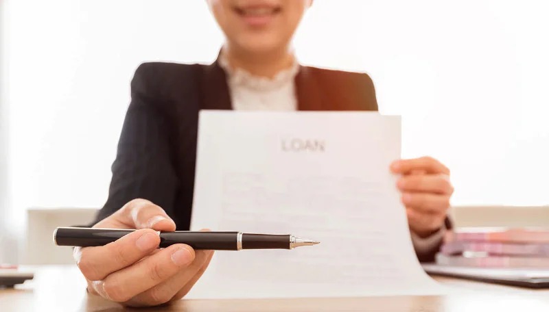Lender handing a pen